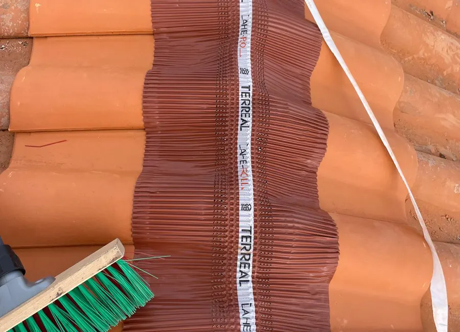 Pose d'un closoir ventilé sous le faîtage d'une toiture en tuiles canal